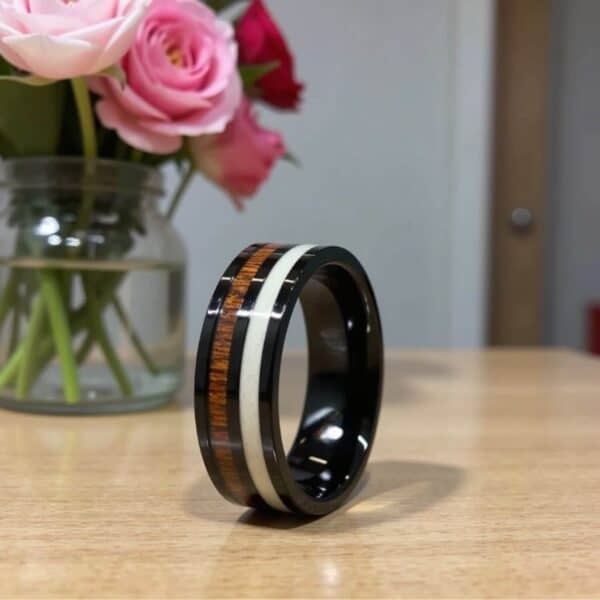 A unique mens ring featuring inlays of wood and antler. This black ring for men is made with tungsten.