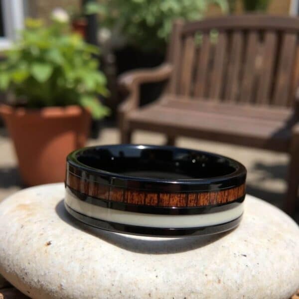 Wood and antler ring for men set within a solid black tungsten band.