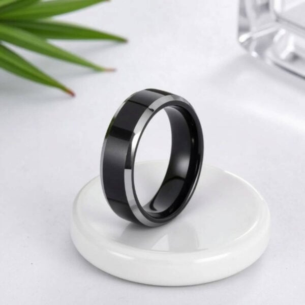 An elegant mans tungsten ring. A male black ring with polished silver edges