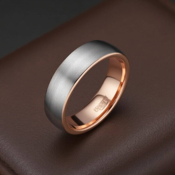 A dapper mens ring crafted from tungsten. Featuring a brushed silver ring with polished rose gold interior.