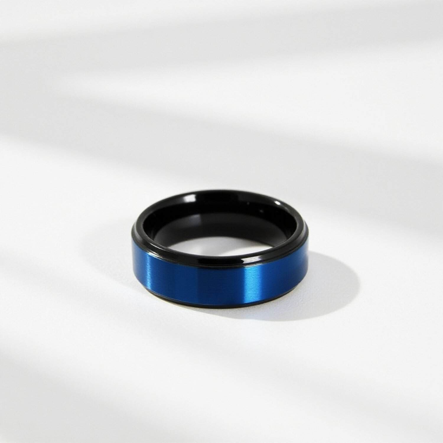 Close up of mens black tungsten ring with blue centre showing side profile in detail