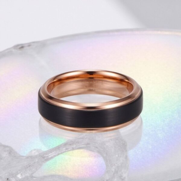 Mans wedding band or engagement ring made with tungsten. Black and rose gold mens ring.