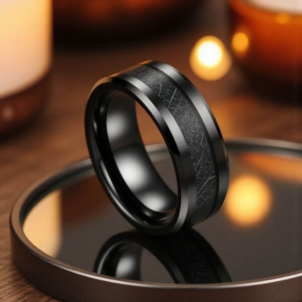 A mans black tungsten ring with faux meteorite inlay