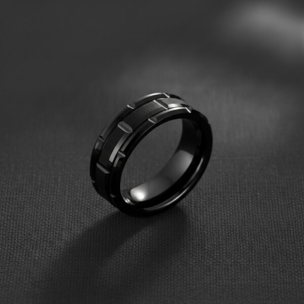 Black tungsten ring for men – The Tyrone mans wedding band featuring a distinctive tyre tread design and sleek modern finish.
