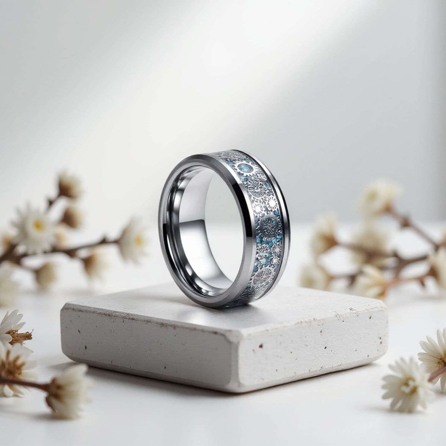 Men’s tungsten ring with a silver finish and blue carbon fibre cogwheel inlay, shown as a personalised men’s wedding band.