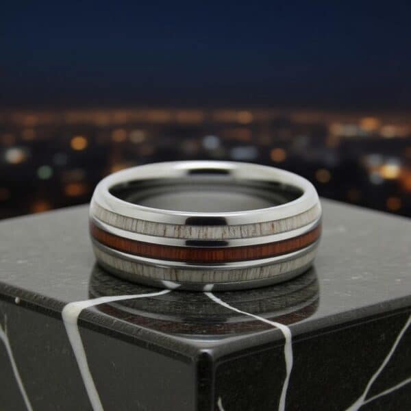 Silver men’s tungsten ring with oak wood and antler inlays, styled as a personalised male wedding band.