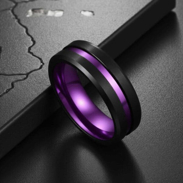 Men’s purple ring with black tungsten exterior and polished purple interior, shown with personalised engraving.