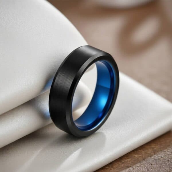 Men’s tungsten ring in black with a vivid blue interior, finished with custom ring engraving.