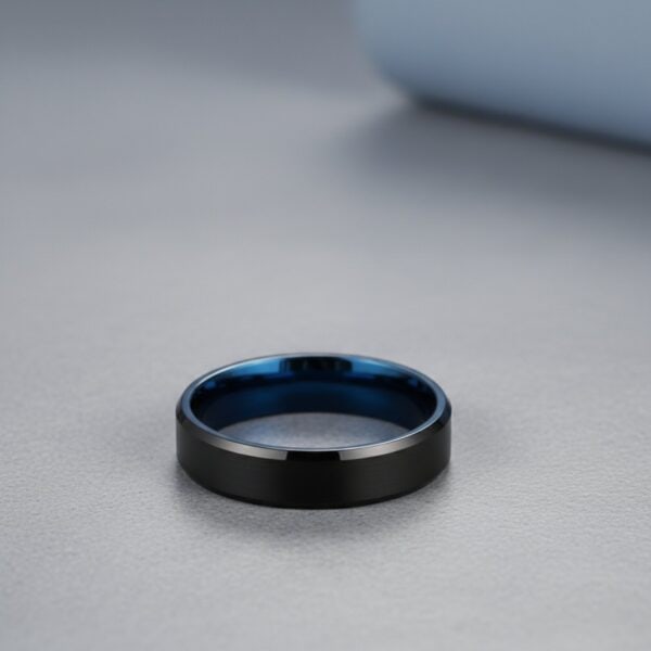 Tungsten ring for men with a brushed black exterior and polished blue interior, shown with personalised engraving.