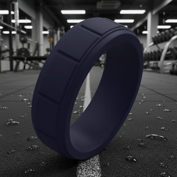 Stylish navy blue mans silicone ring with block pattern. A flexible ring designed as a mens wedding band, gents promise ring, or sports ring for guys