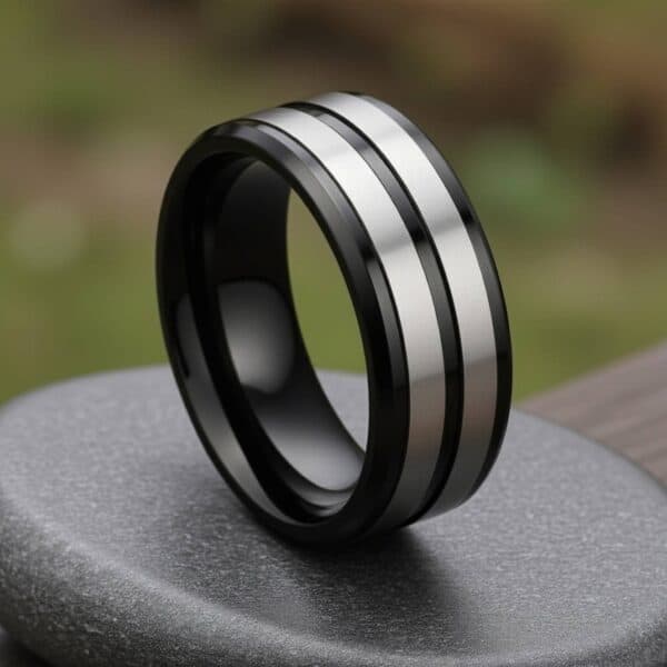 Men’s titanium ring with polished black surface and two brushed silver accents, finished with custom ring engraving.