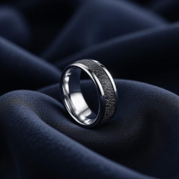 A male fashion statement ring combining tungsten and faux meteorite