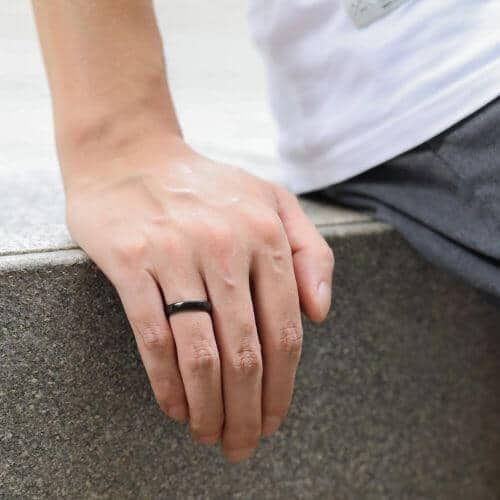 Thin style black ceramic ring on mens finger