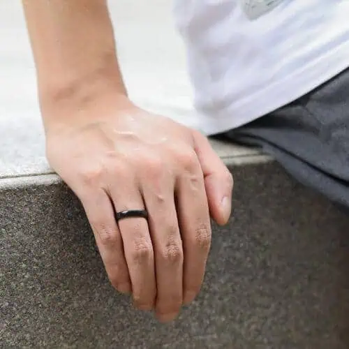 Thin style black ceramic ring on mens finger