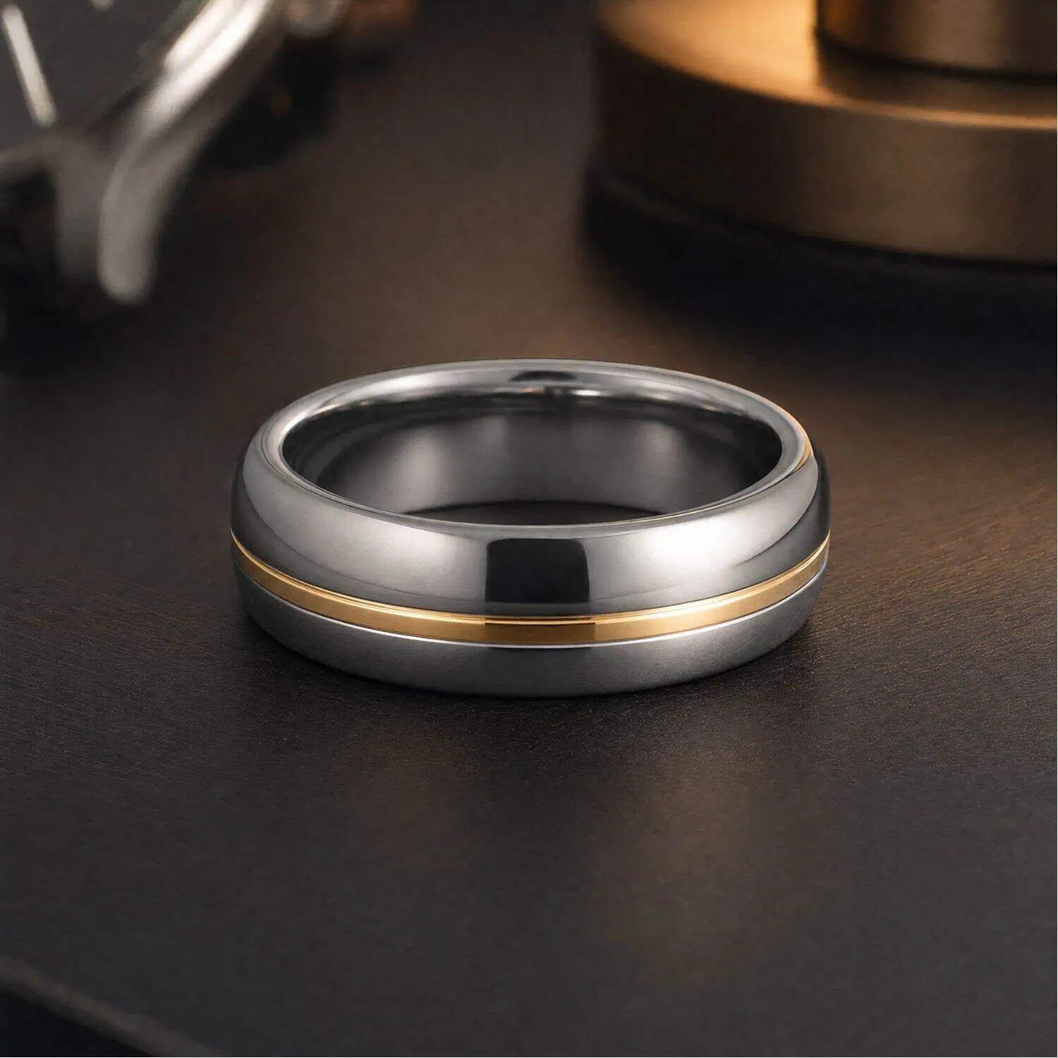 Men's silver tungsten ring with a polished gold centre groove displayed flat against a clean minimalist background.