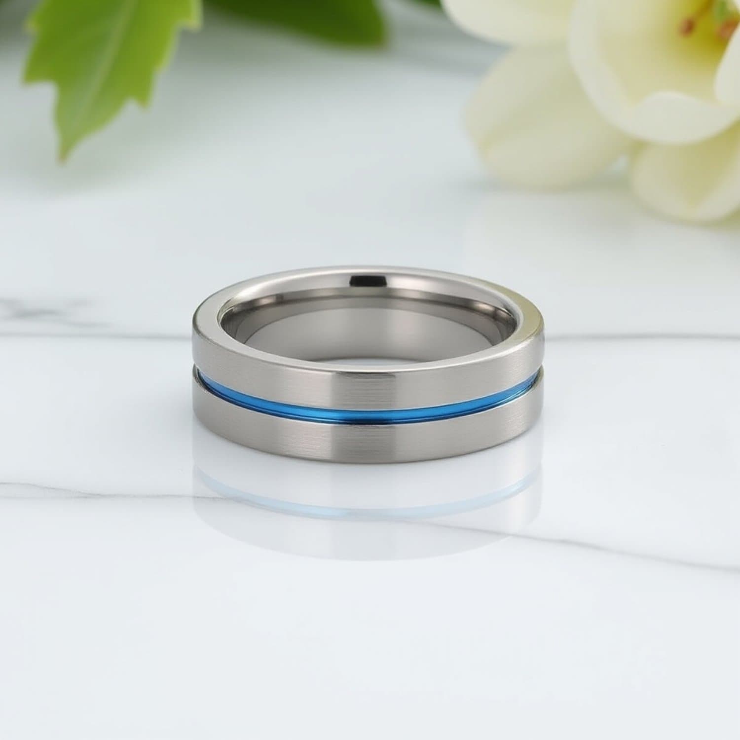 The Negotiator men’s tungsten wedding ring with brushed silver body, blue groove, flat profile, and engraving option for him.