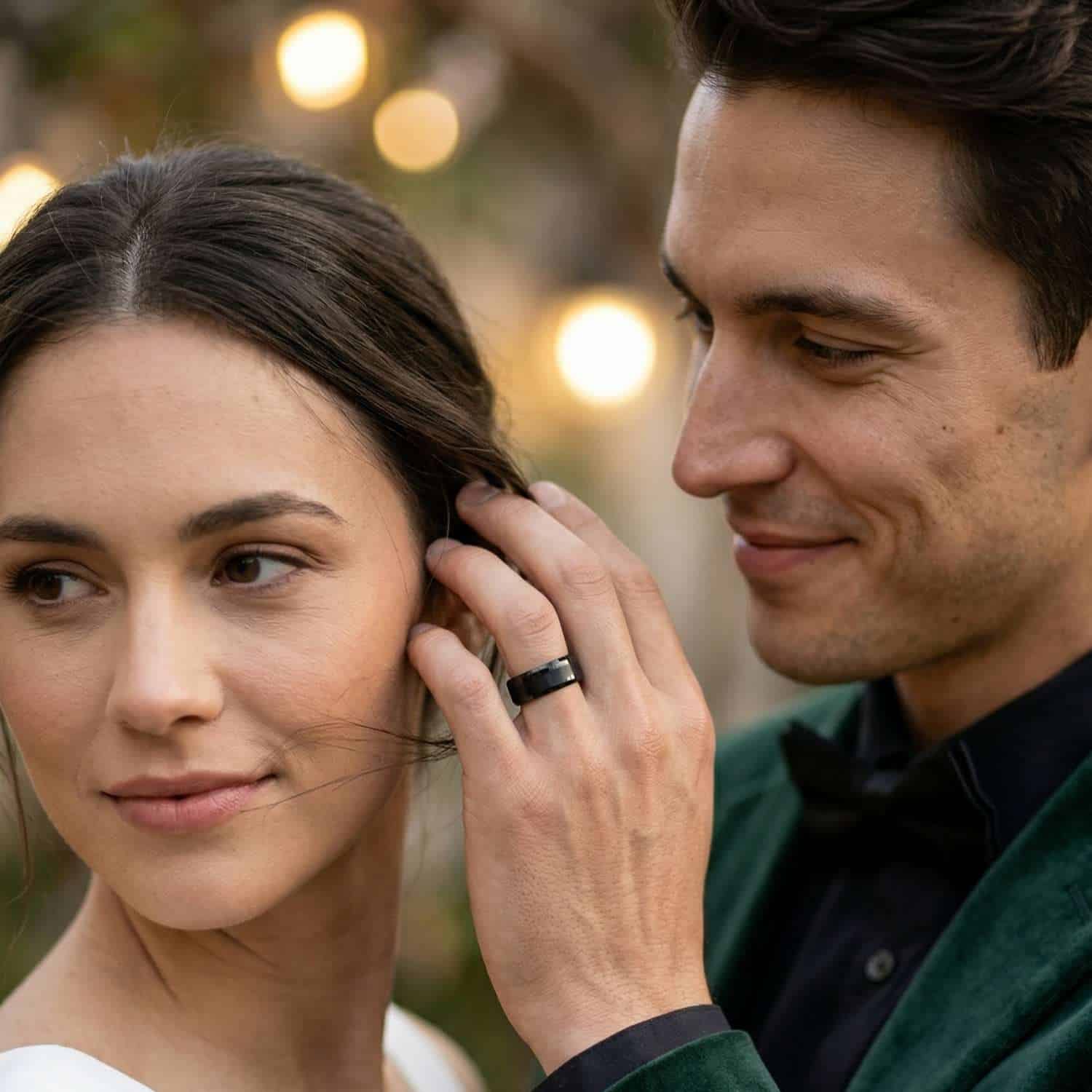 Man brushing partner’s hair with hand wearing black tungsten ring with brushed centre and bevelled edges