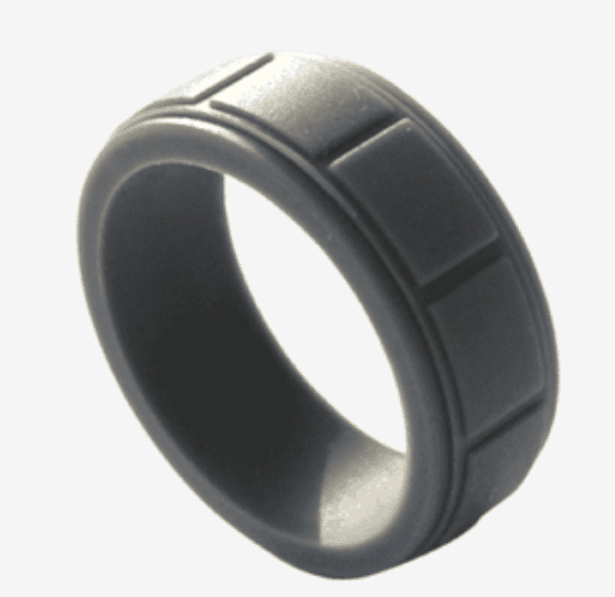 Black silicone ring with a matte finish and raised rectangular segments, designed for durability and comfort ideal for active lifestyles and modern wedding bands.