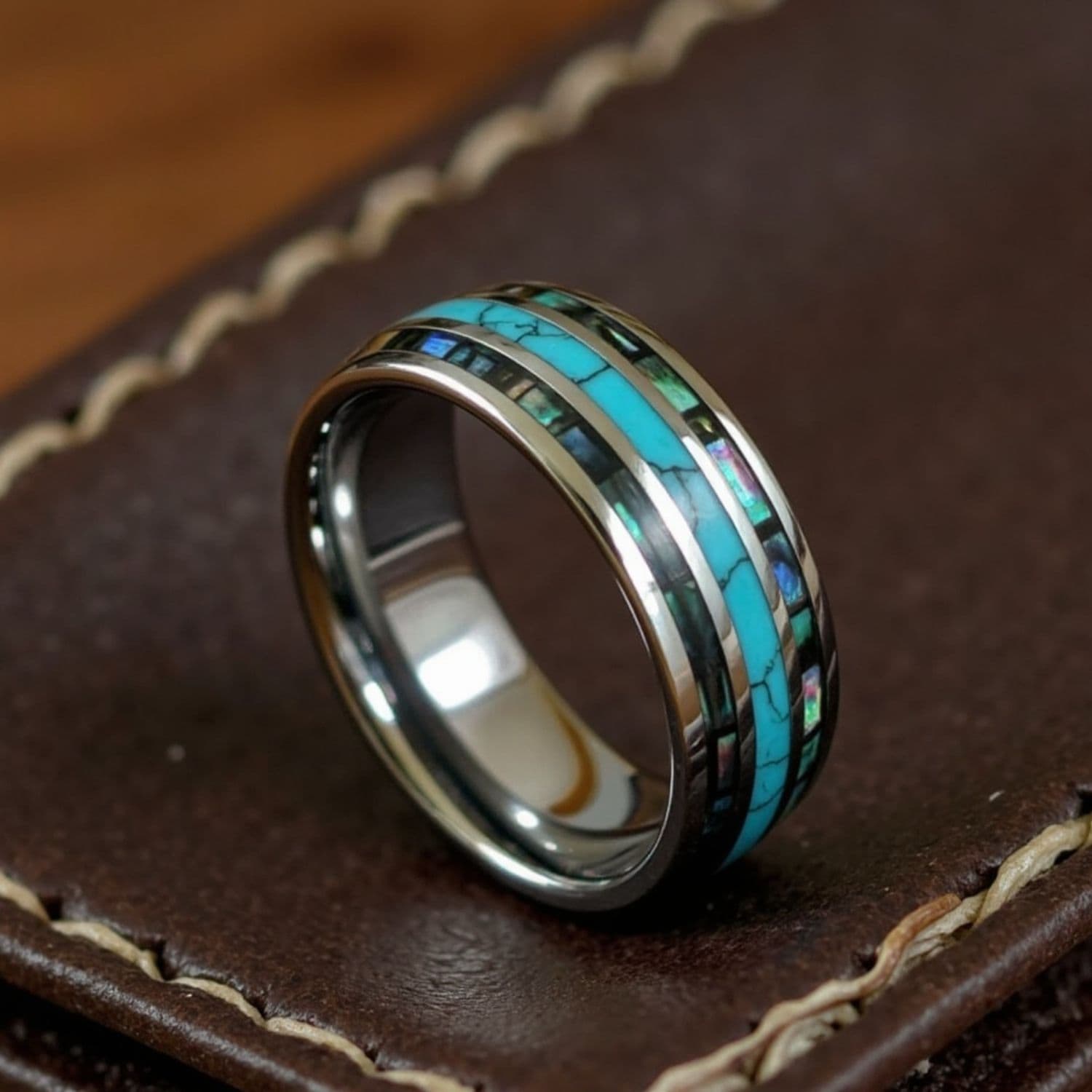 Tungsten men’s wedding band featuring turquoise and abalone shell inlays, with custom engraving.