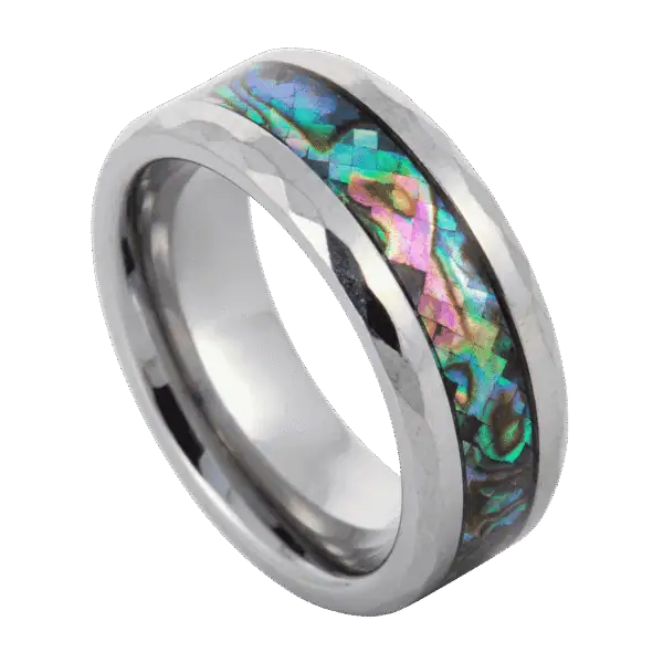Close-up of the Reef silver tungsten carbide ring featuring a shimmering abalone shell inlay and multi-faceted bevelled edges against a clean background.