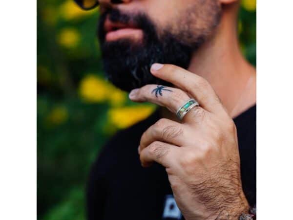 Man wearing abalone shell ring. Tungsten abalone shell gents ring with engraving option, ideal as an eternity or wedding band.