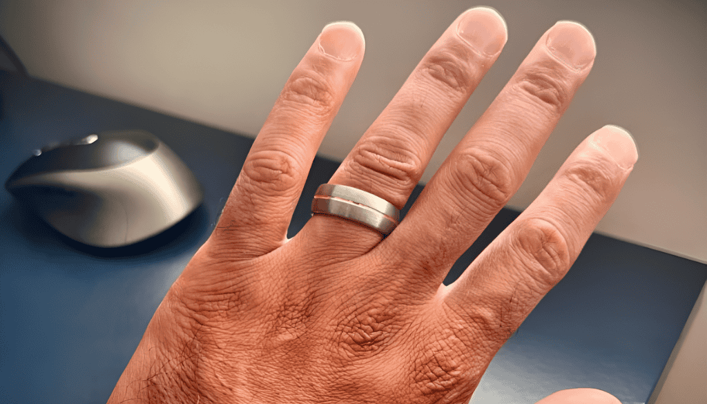 Close-up of a man’s hand wearing a ring, showcasing fit and placement on the finger — ideal for illustrating ring style, size, and everyday wear.