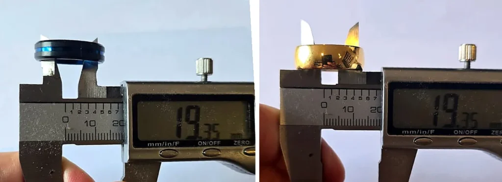 Digital calipers measuring the inside of two size T men's rings, a black and blue titanium band and a gold tungsten band, both reading 19.35mm