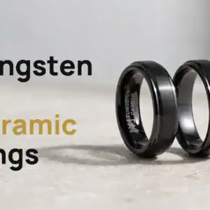 Tungsten vs ceramic rings: a black tungsten ring and its black ceramic twin standing side by side on stone