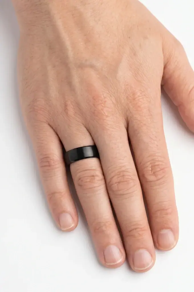 The Vitality brushed black titanium ring worn on the ring finger