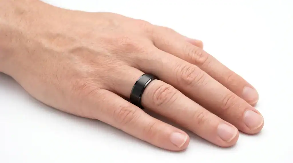 The Acute black titanium ring worn on the ring finger