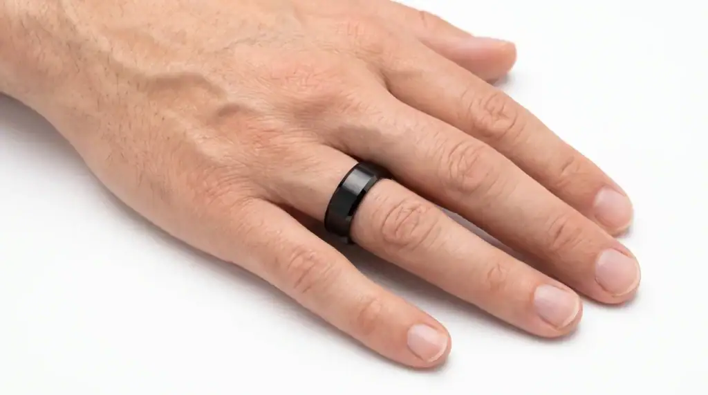 The Strength black tungsten ring with brushed centre and polished bevelled edges worn on the ring finger
