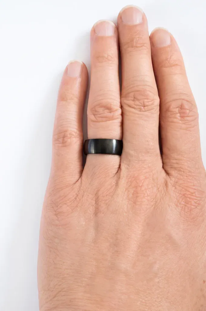 The Jet brushed black tungsten ring worn on the ring finger