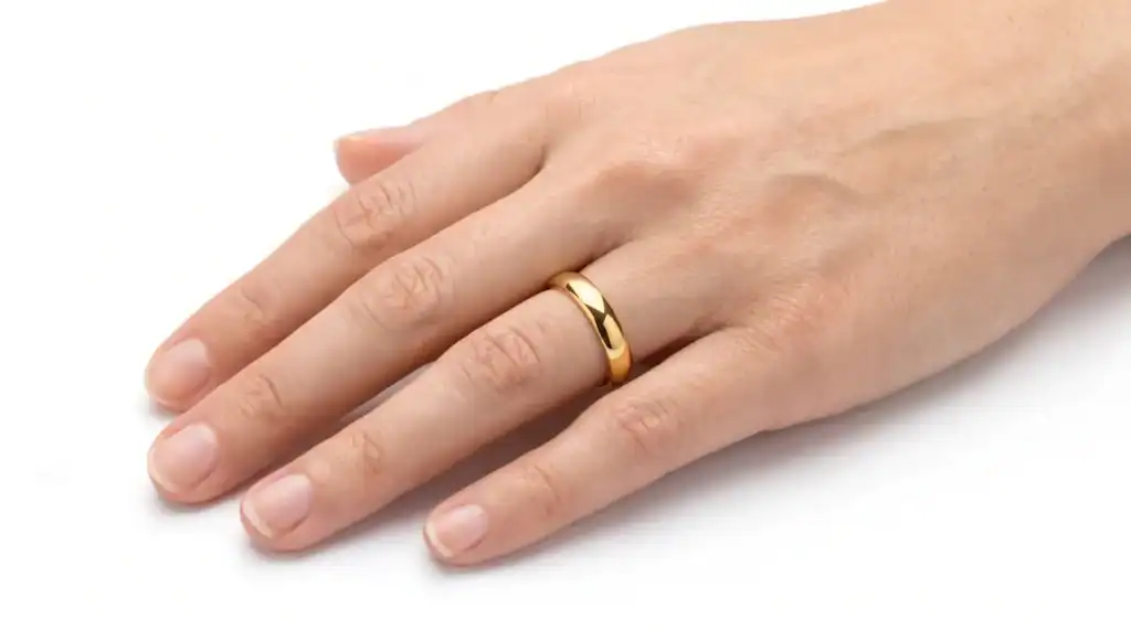 The King Thin Style 4mm polished gold-coloured tungsten ring worn on the ring finger of a man's hand