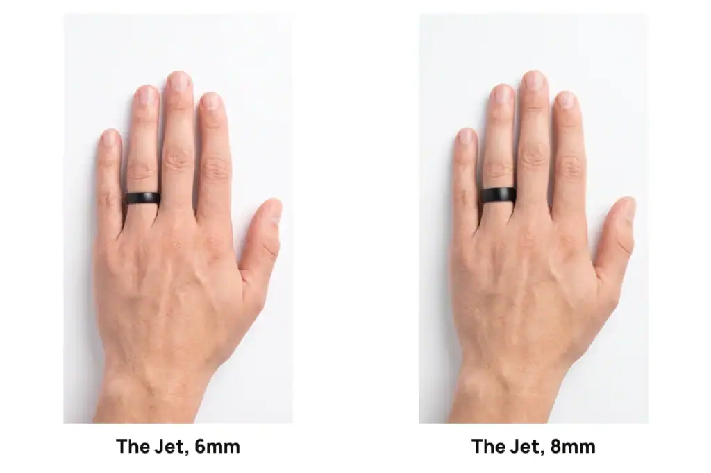 The Jet brushed black tungsten ring in 6mm and in 8mm, each worn on the ring finger of a left hand on a white studio surface, the 8mm visibly wider