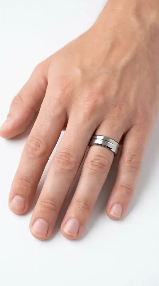 Milan silver tungsten ring from Newman Bands worn on a man's ring finger