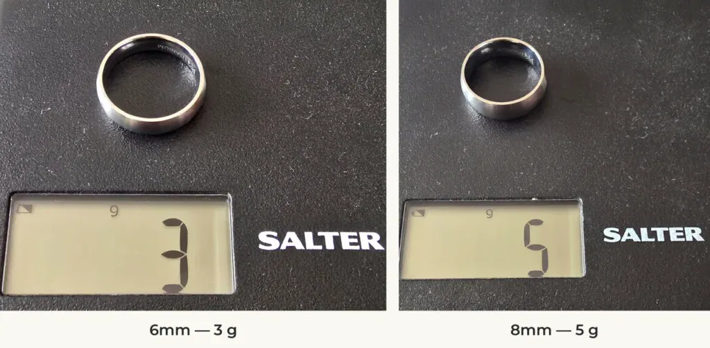 The Tranquil 6mm and 8mm silver-coloured titanium rings on a Salter scale reading 3 g and 5 g