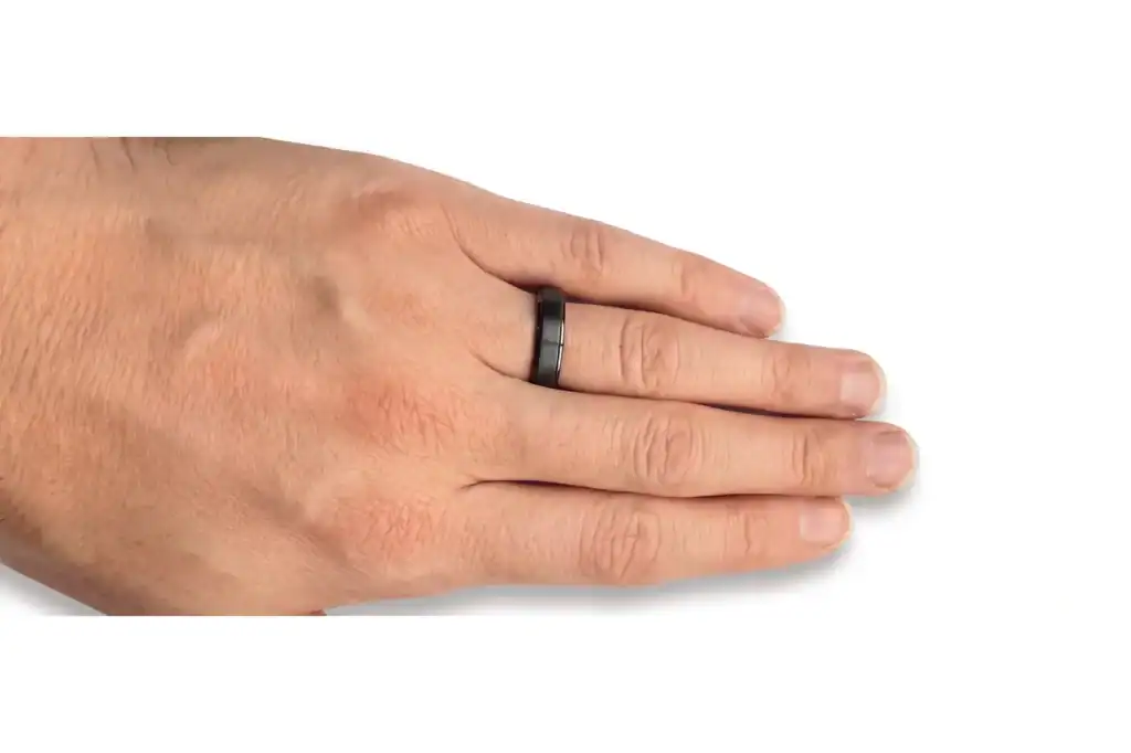 A black 6mm ring with a brushed centre and polished stepped edges worn on a man's hand